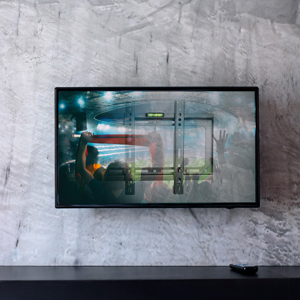black television on gray concrete wall suport TV 127 cm